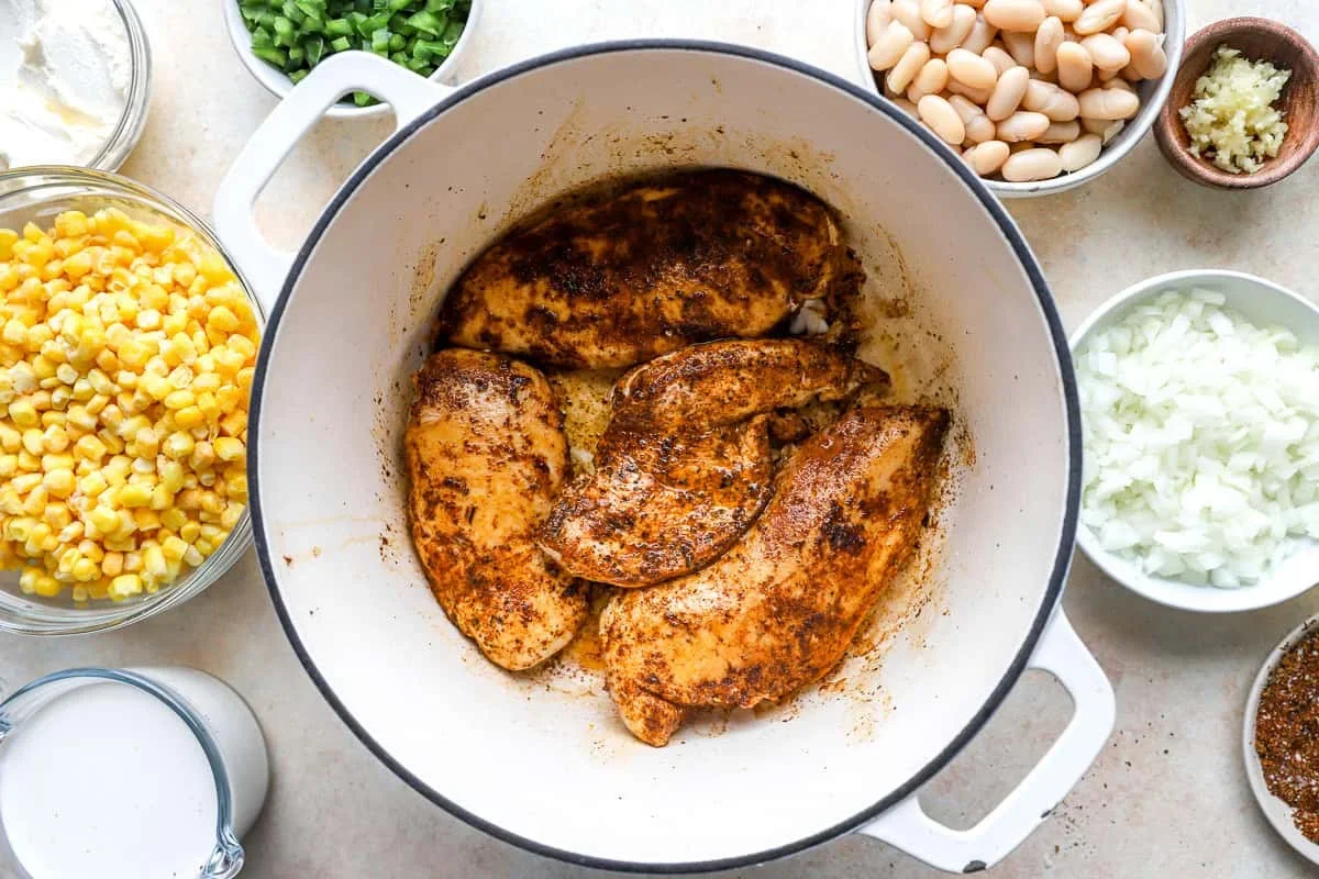 onions and jalapeños cooking in pot for street corn chili