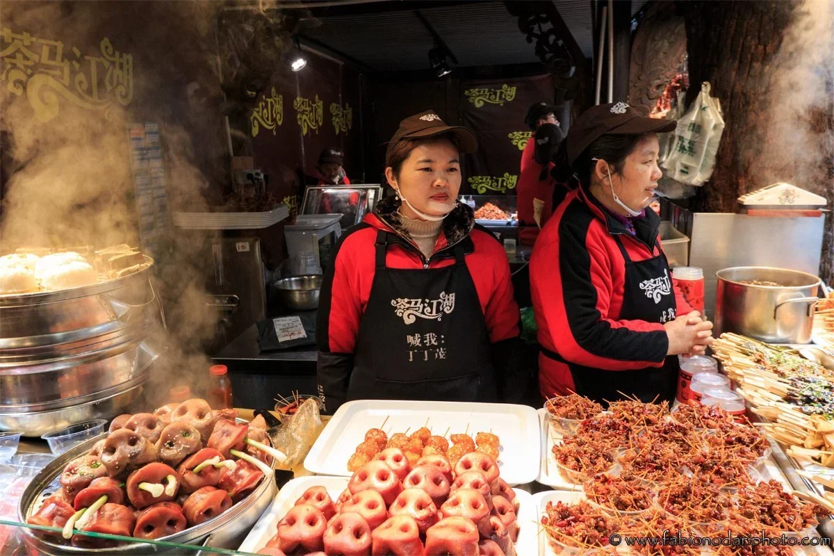 fresh seafood selection at Shenzhen harbor market with crabs and fish in tanks