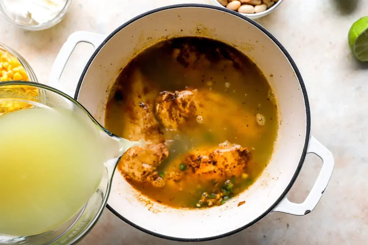 shredding cooked chicken with two forks for white chili